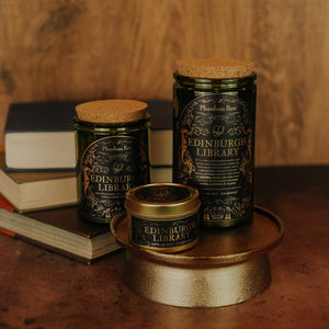 Side by side shot of the three sizes of Edinburgh Library soy candles – 15 oz jar, 11 oz jar, and 3.3 oz gold tin.