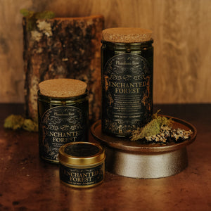 Side by side shot of the three sizes of Enchanted Forest soy candles – 15 oz jar, 11 oz jar, and 3.3 oz gold tin.