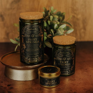Side by side shot of the three sizes of Fairy Springs soy candles – 15 oz jar, 11 oz jar, and 3.3 oz gold tin.